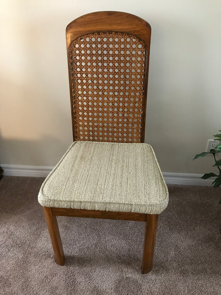 Dining chair, wood finish with woven cane inlay and padded cushion.