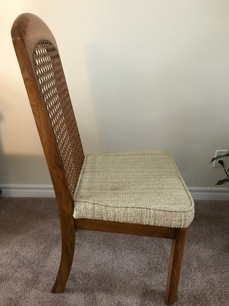 Dining chair, wood finish with woven cane inlay and padded cushion.