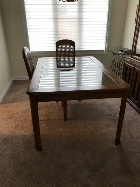 Dining room table, wood finish with glass and woven cane inlay.